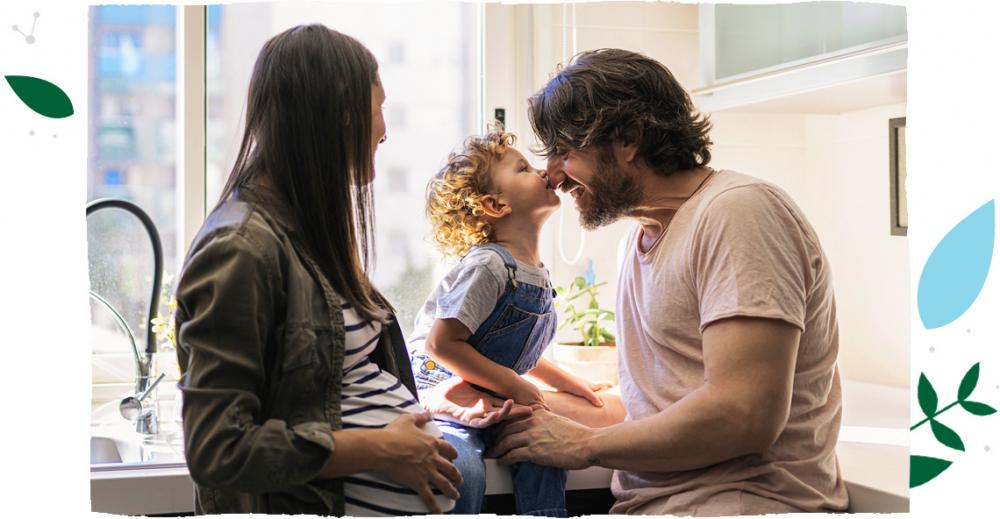 a woman, man and child smiling